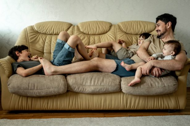 A large family spends time sitting at home on the couch. Communication between parents and children