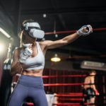 Asian sportswoman using innovative technology VR glasses for exercise.