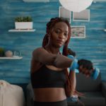 Athletic slim woman with sportswear practicing gymnastics sport workout