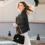 attractive woman walking in street in fashionable outfit