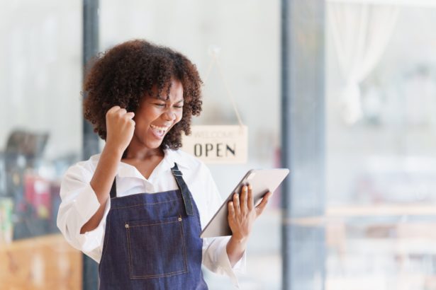 Beautiful American African Businesswoman start small business. A woman works from home delivering
