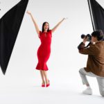 Behind the scenes of photoshoot. Elegant woman posing for professional fashion photographer shooting