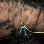 man bungee jumping in the mountain nature and adrenaline