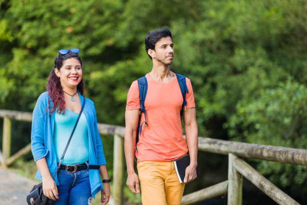 mixed race couple trekking in senda del oso, Asturias. Mid adult ecotourism in Proaza